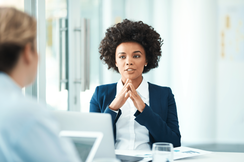 woman in office with fingertips touching