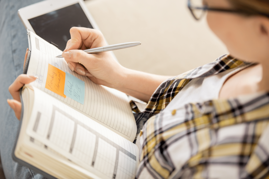 woman writing New Year’s Resolutions for Sobriety 