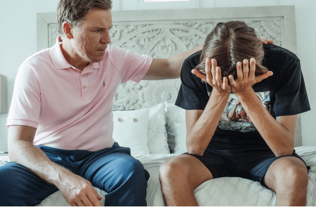 Man comforting his son and trying to break the drug addiction cycle in families.